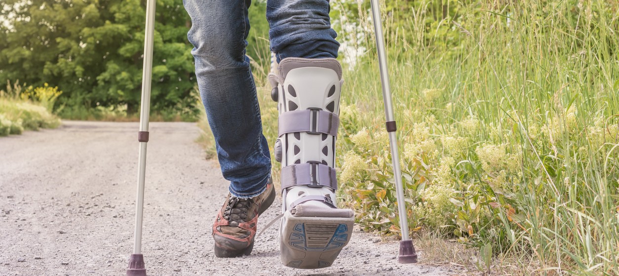 person-with-walking-boot-and-crutches